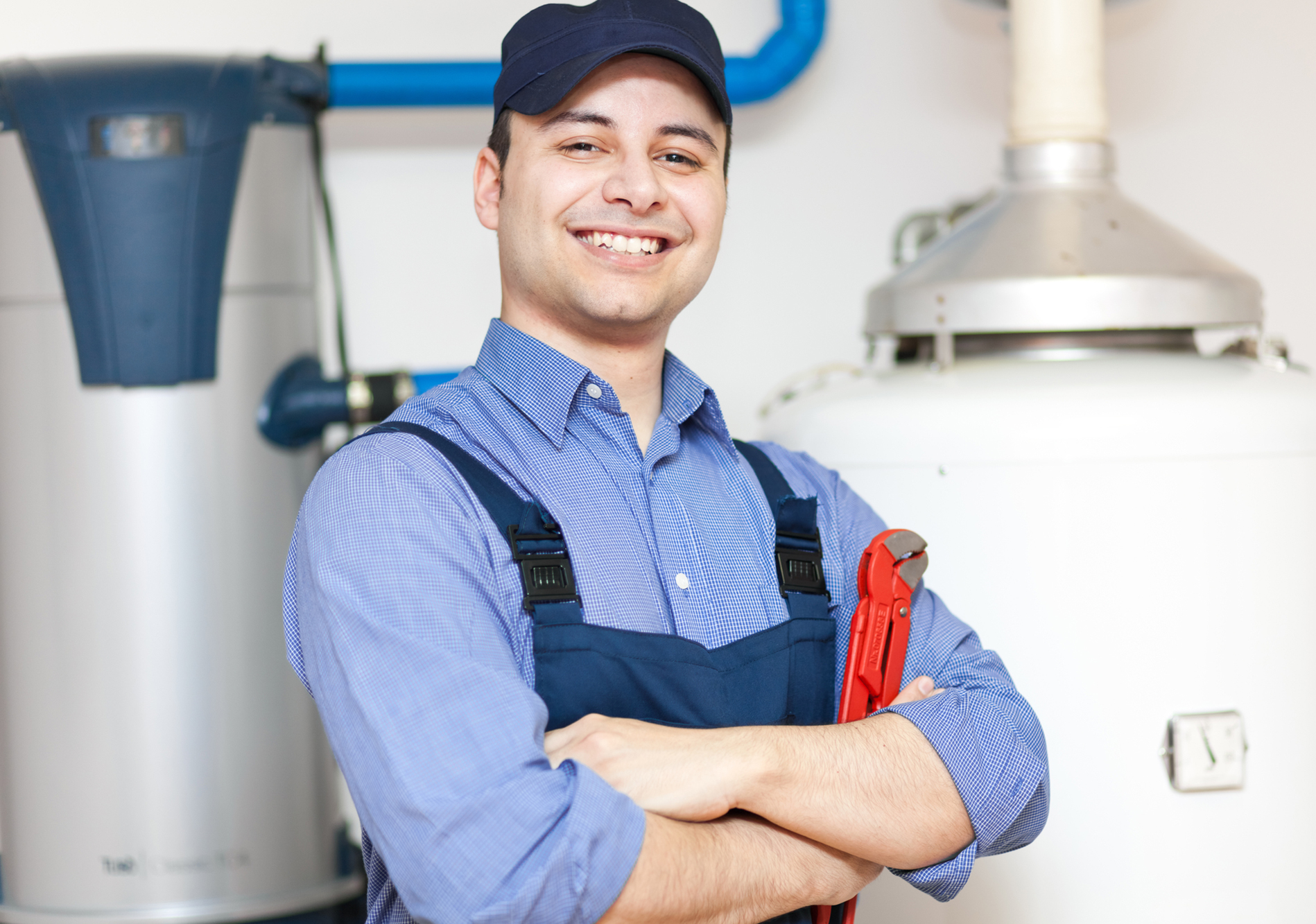 Smiling Plumber Repairing Hot-water Heater